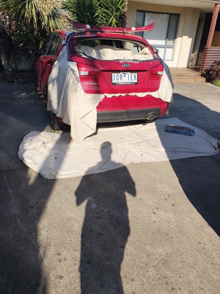 Rear glass replacement on a driveway